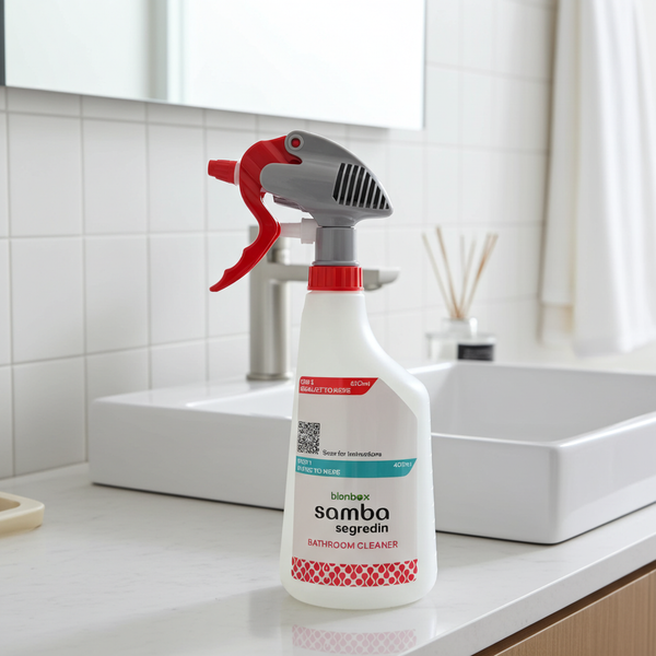 Bathroom cleaner spray bottle on a bathroom counter with a sink and mirror in the background.