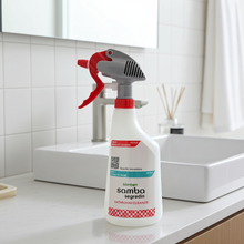 Bathroom cleaner spray bottle on a bathroom counter with a sink and mirror in the background.