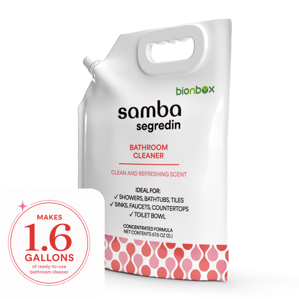 Bionbox Samba Segredin bathroom cleaner refill pouch with a pink patterned base, shown on a white background with a pink circular badge that reads 'Makes 1.6 gallons of ready-to-use bathroom cleaner.